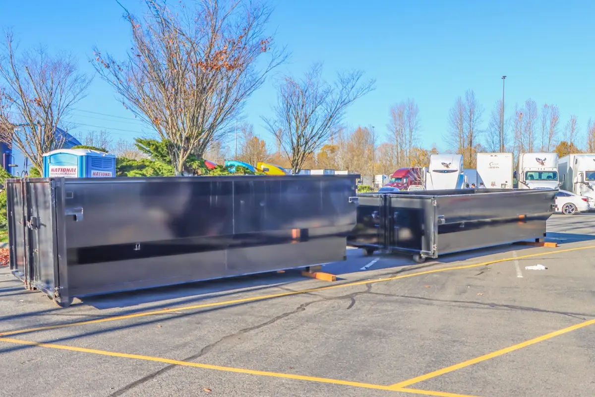 Professional dumpster rental service with roll-off container on residential driveway in Margate